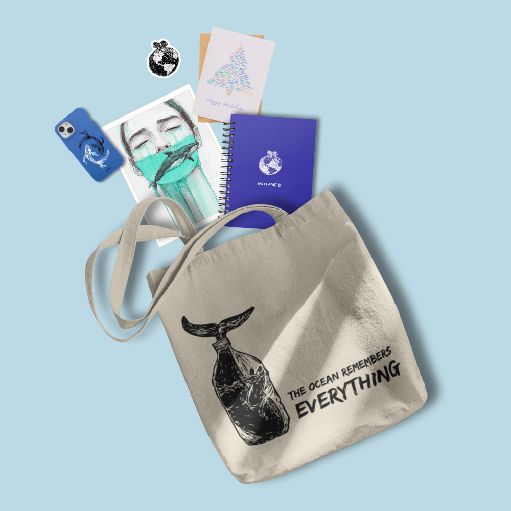 Tote bag with whale design and related products on a light blue background